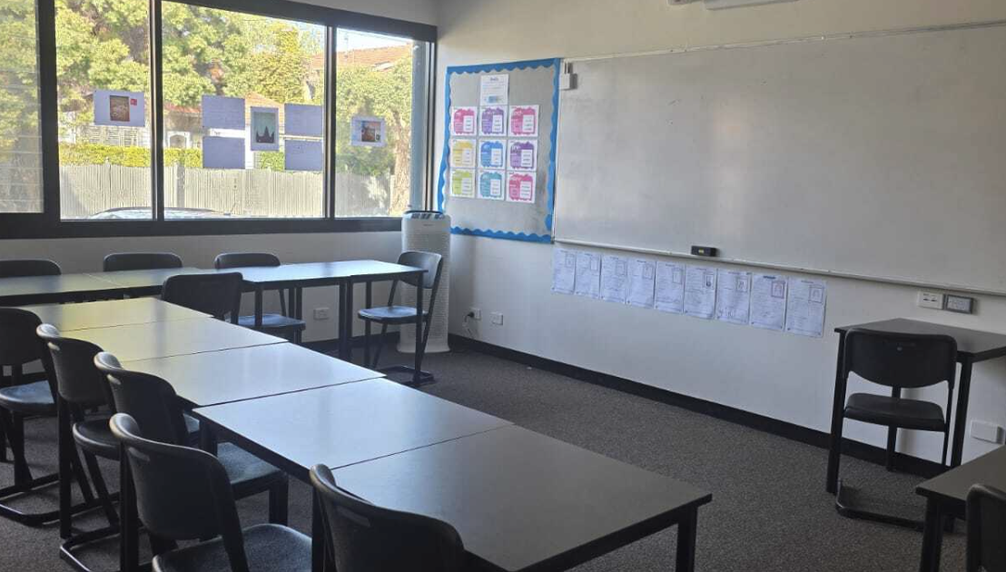 Bright classroom with whiteboard and student desks